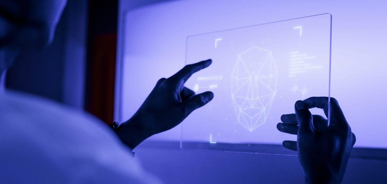 Designer using a transparent digital tablet screen futuristic te